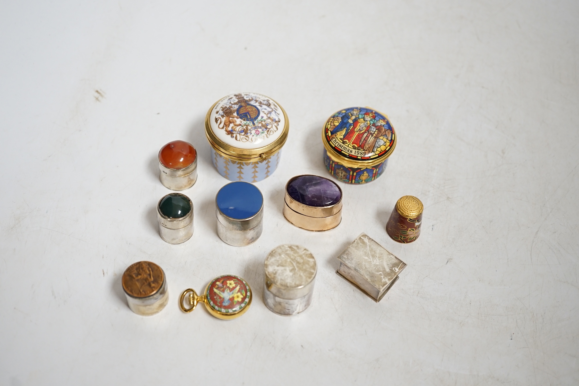A collection of patch boxes including some silver, a gilt metal and amethyst example, Halcyon Days enamel and a miniature yellow metal love heart locket stamped 375, largest 4.5cm diameter. Condition - mostly good